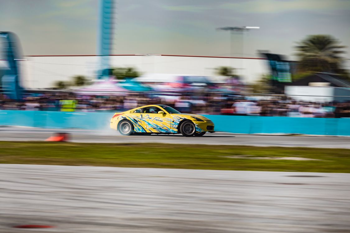 Yellow Turn Racing A yellow car is driving on a track · Free Stock Photo