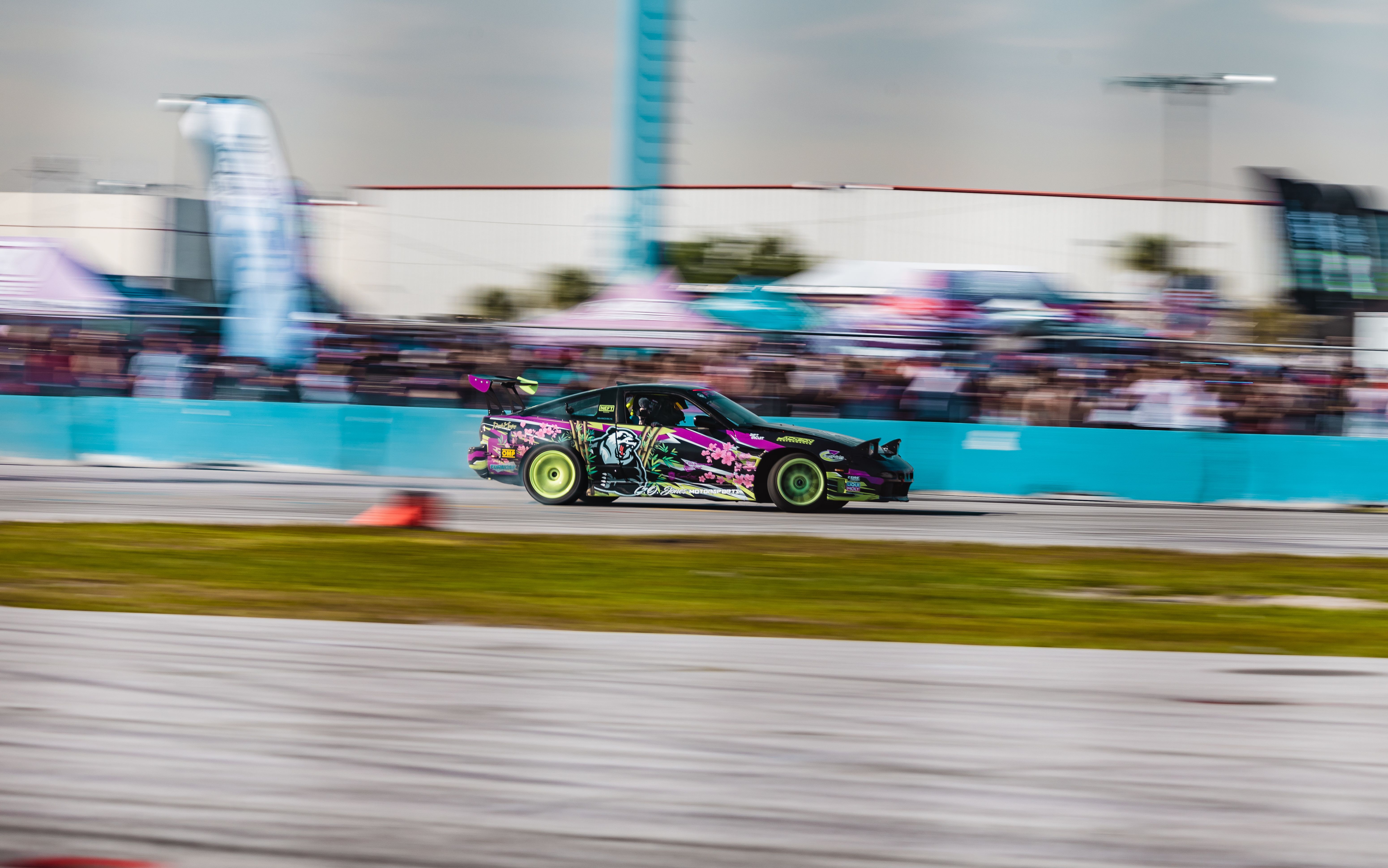 A car is racing on a track · Free Stock Photo