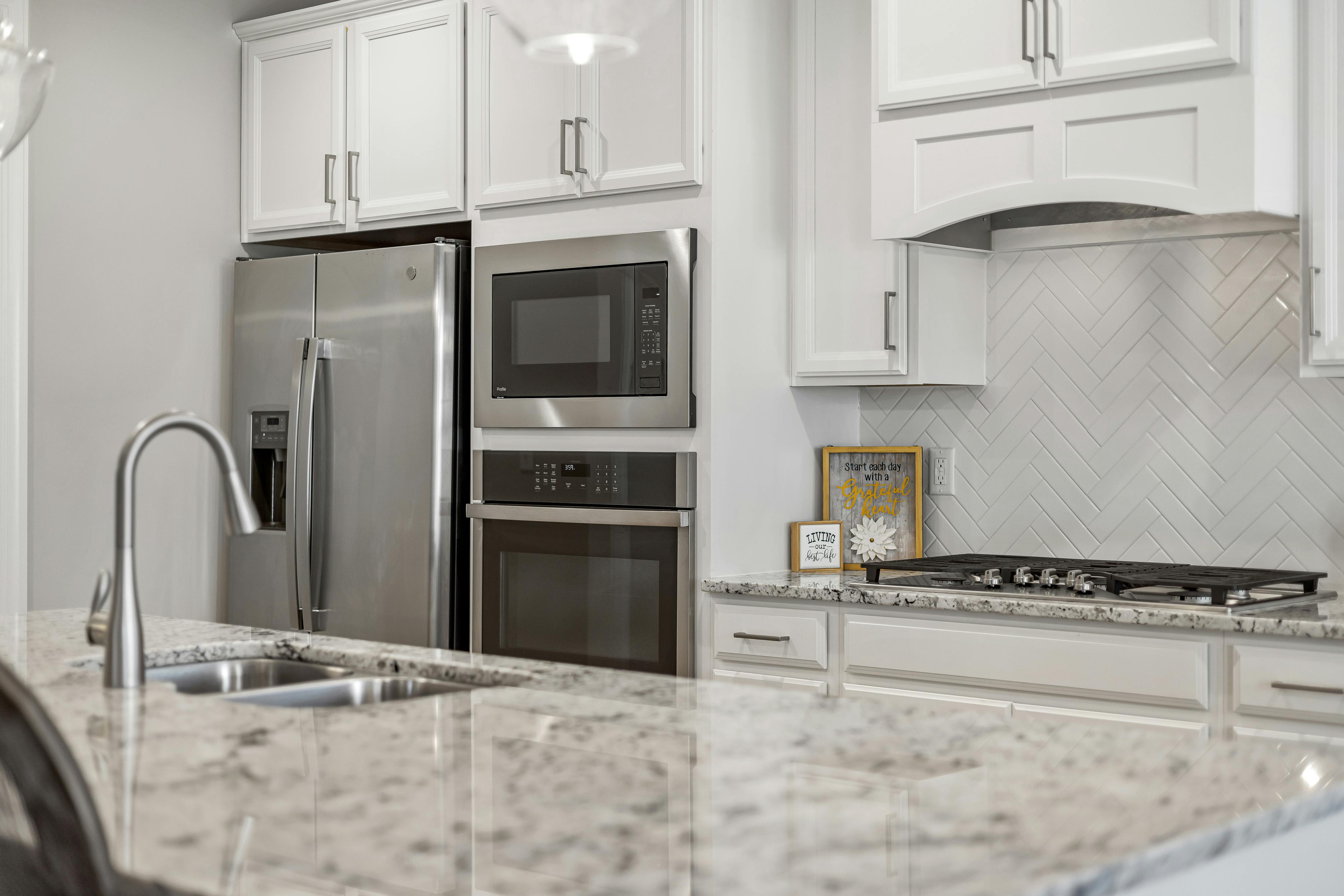 white herringbone pattern backsplash in the kitchen