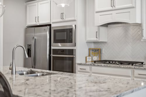 Free Sleek and stylish modern kitchen featuring stainless steel appliances and granite countertops. Stock Photo