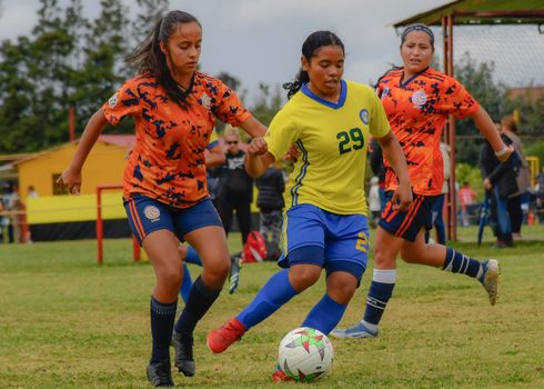 Action-packed soccer match with teenage girls competing on a grassy field.