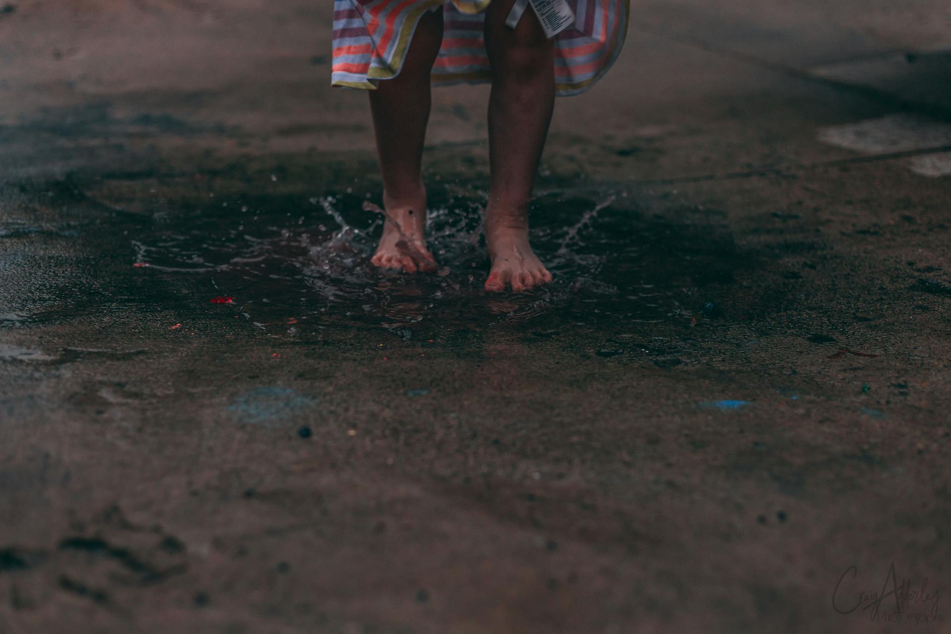 Person Standing On Puddle Of Water