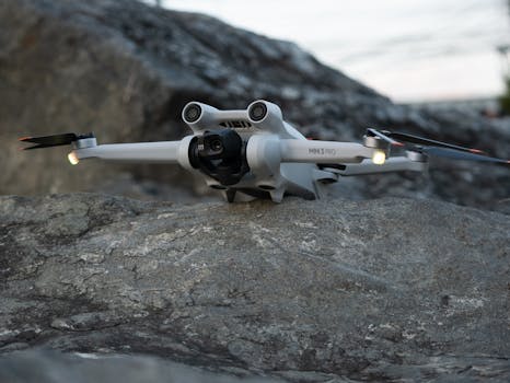 Sleek and advanced camera drone poised on a rugged rock surface, ready for action.