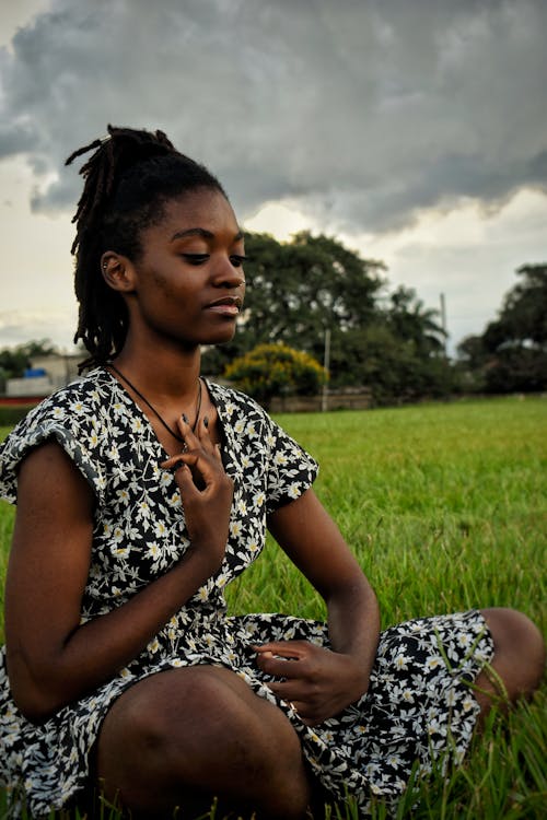Woman Sitting on Grass Meditating