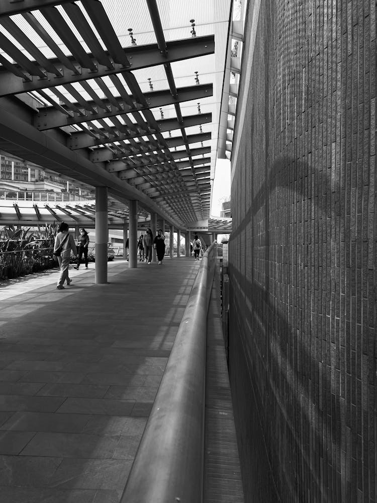 People Crossing Wall At Subway Station