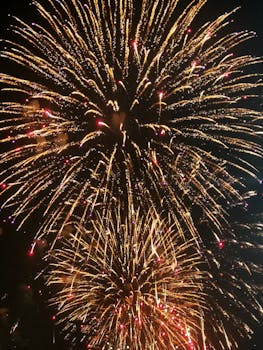 Vibrant golden fireworks light up the night sky, perfect for festivals and celebrations.