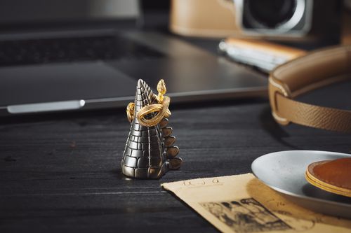 Free Close-up of a silver and gold snake ring resting on a dark surface, showcasing intricate details. Stock Photo