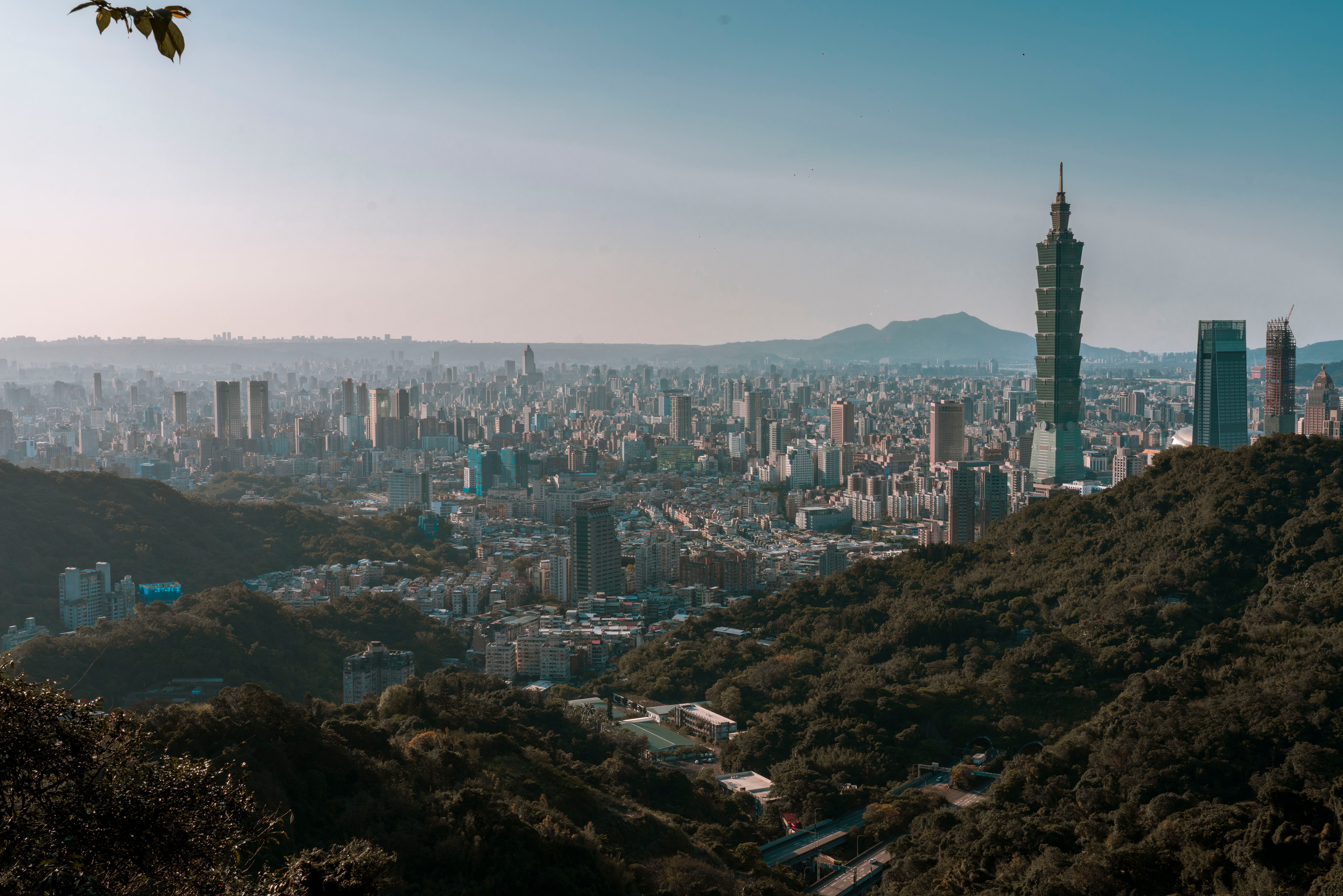The Taipei skyline from above with Taipei 101 rising over the city