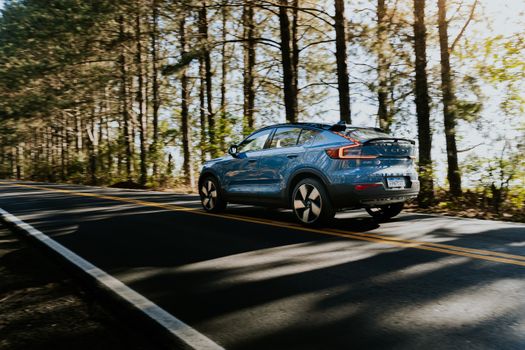 Blue Volvo C40 Recharge on an Asphalt Road 