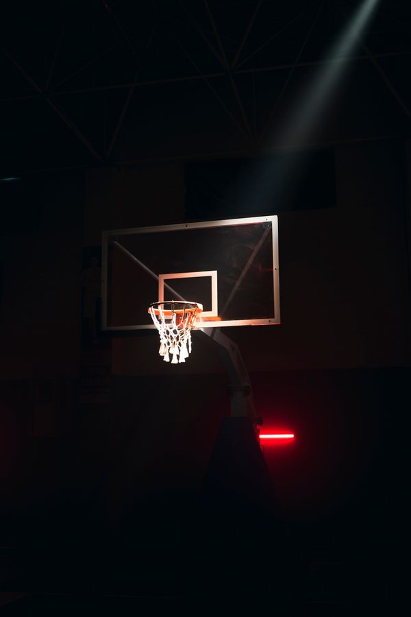 Hoop lit by a single spotlight — photo by Burak The Weekender on Pexels