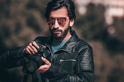 Man Holding Black Canon Dslr Camera