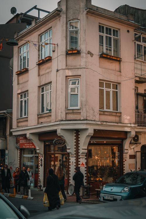 Free Charming urban street corner in Turkey with people walking by historical buildings. Stock Photo