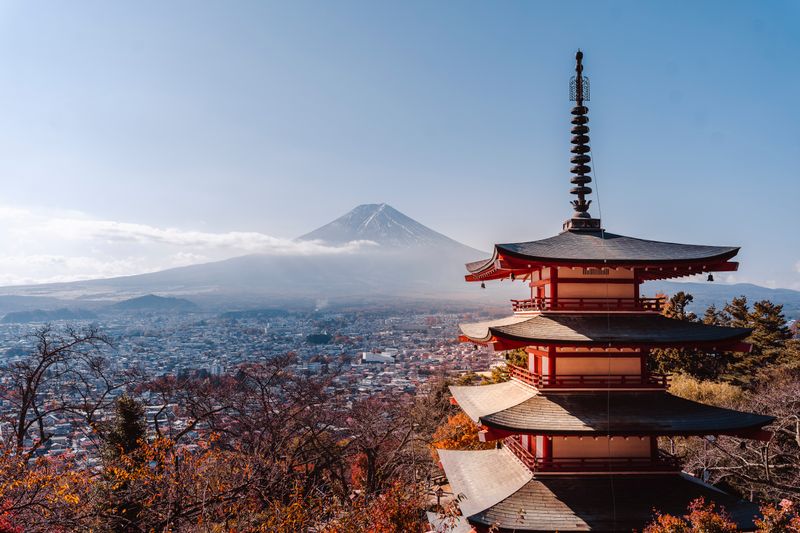 Chureito Pagoda with Mount Fuji in autumn — five-storey pagoda framing snow-capped Fuji above the valley, Fujiyoshida, Yamanashi