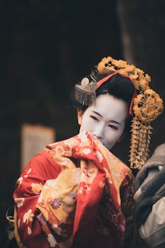 Portrait of a geisha in vibrant traditional clothing, capturing a candid moment.