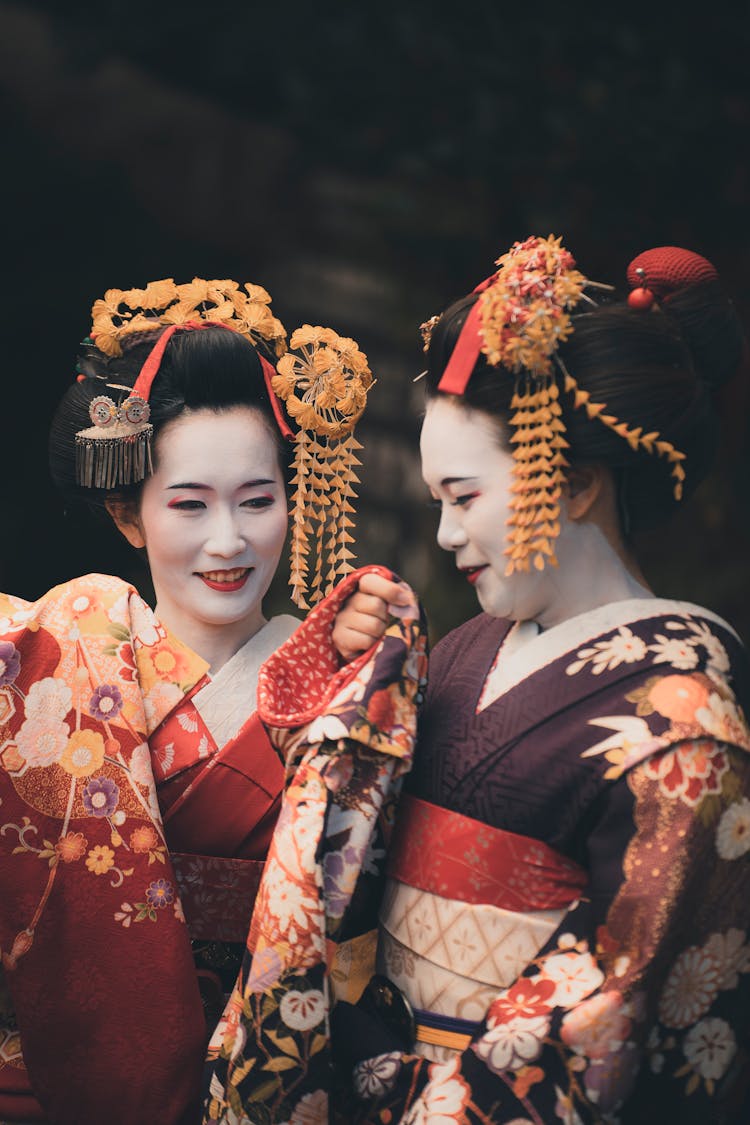 Two Geishas Talking And Smiling 