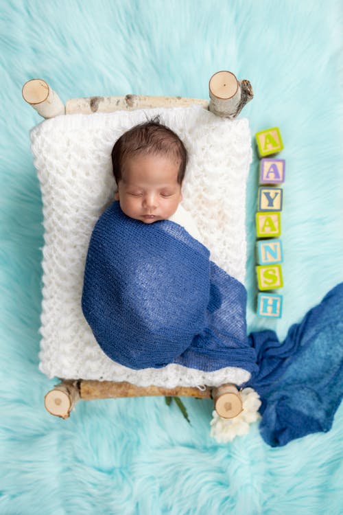 Free A Baby Boy Wrapped in a Nappy Lying on a Blanket  Stock Photo