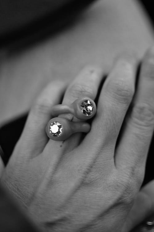 Black and White Photo of a Ring on a Hand 
