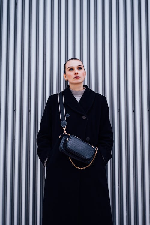 Woman in a Black Coat and a Bag 