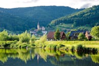 Brown Grey Wooden House Near Lake at Daytime