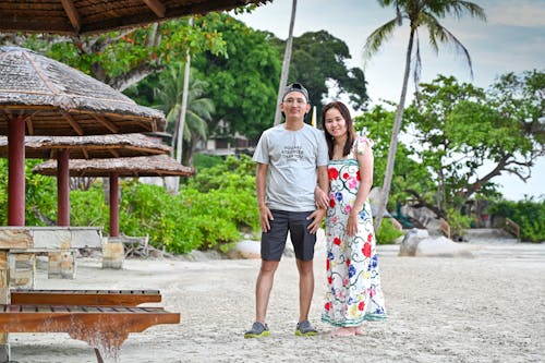 A Couple Standing on the Beach during Vacation 