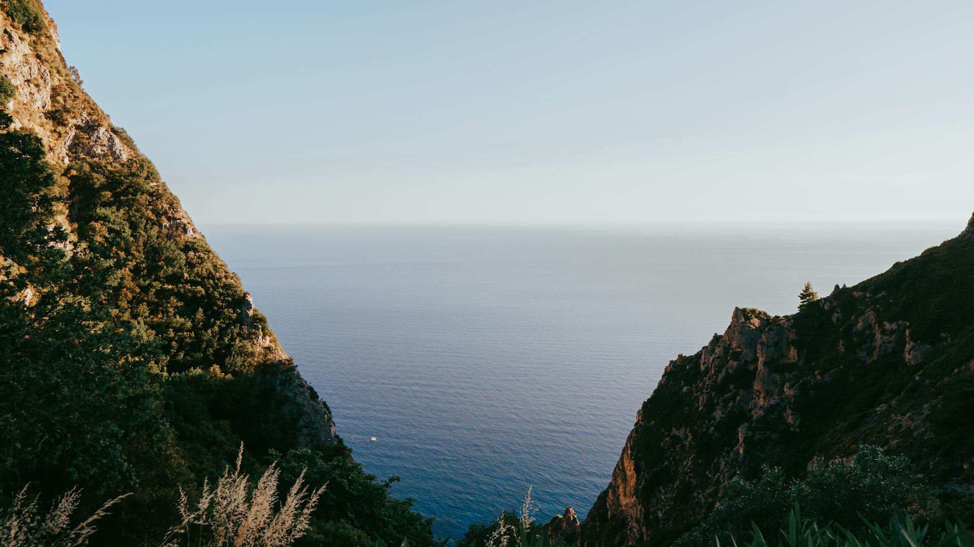 Breathtaking cliffs overlooking the serene Ionian Sea in Kerkyra, Greece during summer.
