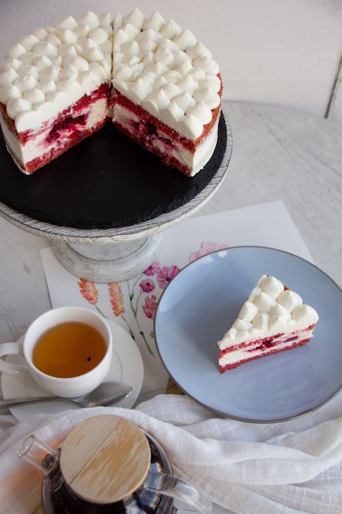 Raspberry Cake with Meringue and Tea on a Table