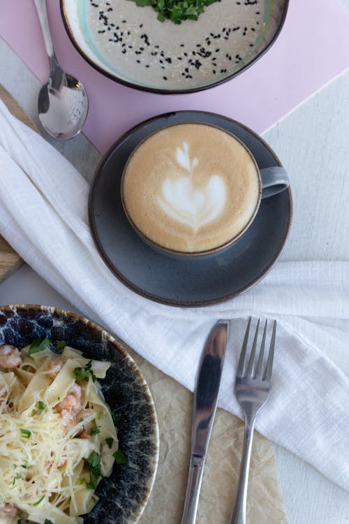 Free Top View of a Spaghetti Dish and a Coffee with Foam Stock Photo