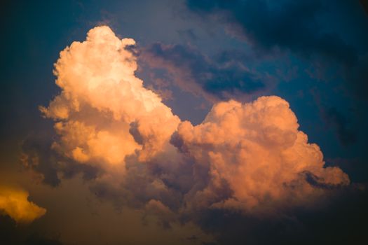 Vibrant orange clouds during sunset sky, capturing the beauty of nature's dramatic cloud formations.