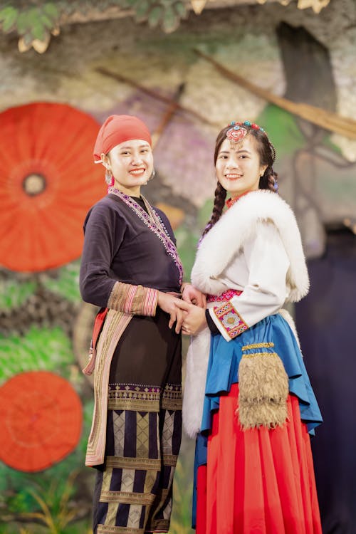 Women Posing Together in Traditional Clothing