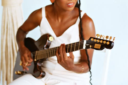 Midsection of a Young Woman Playing a Guitar