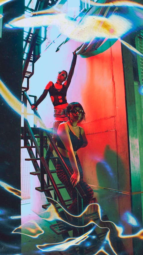 Women Posing on Stairs in Red Light