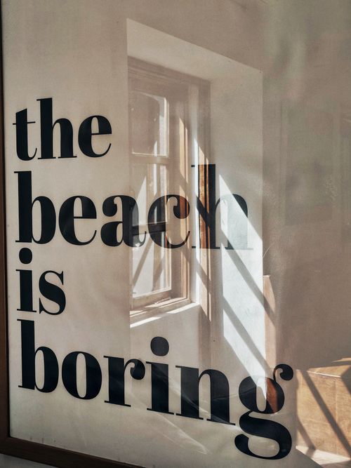 Free Photo of a framed quote in a sunlit room, reflecting light and shadows. Stock Photo