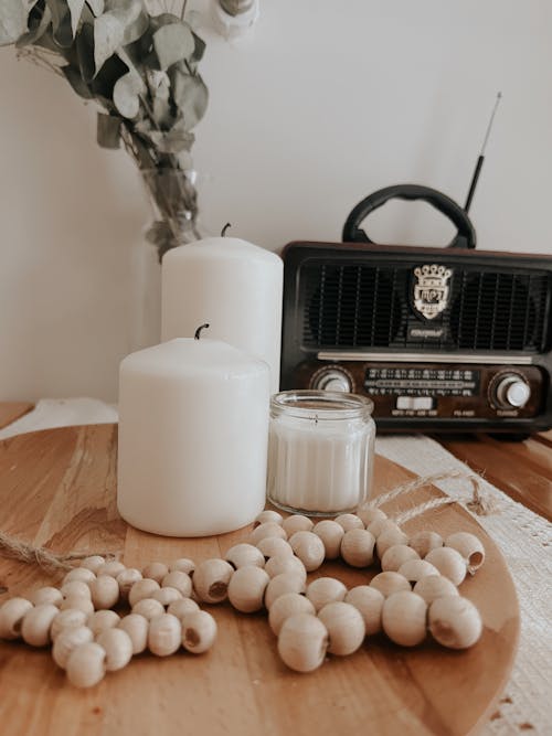 White Candles and a Radio on a Table