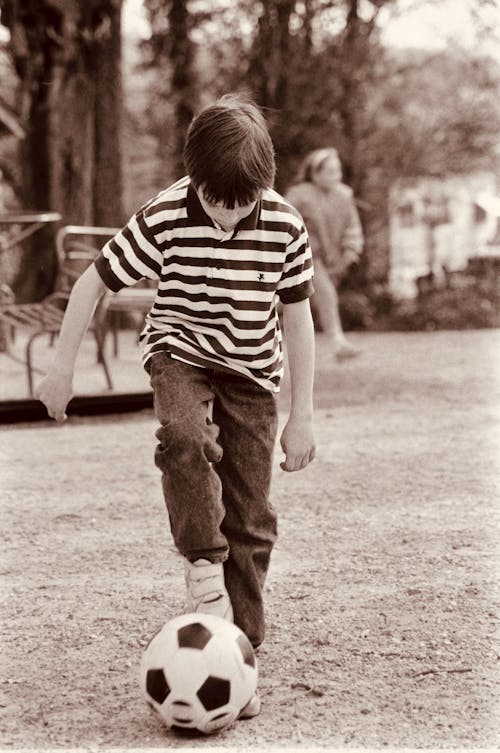 Sepia Picture of a Boy Playing Soccer 