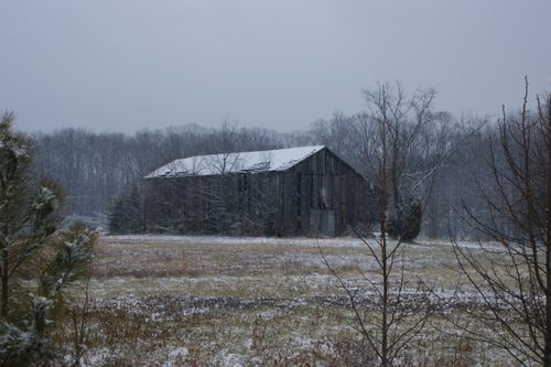 Free A vintage wooden barn stands in a snowy rural landscape in Chemung, NY. Stock Photo