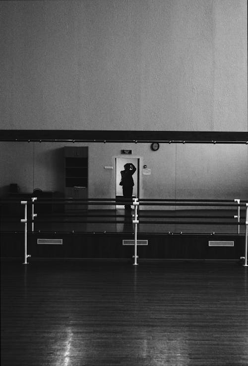 Silhouette of the Photographer in the Reflection of the Dance School Mirror