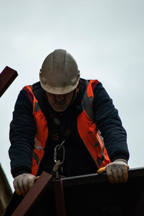 A Construction Worker in a Reflective Vest and a Helmet 