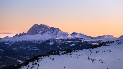 Free Stunning view of snow-covered Dolomites during sunrise, showcasing majestic mountain peaks and vibrant sky. Stock Photo