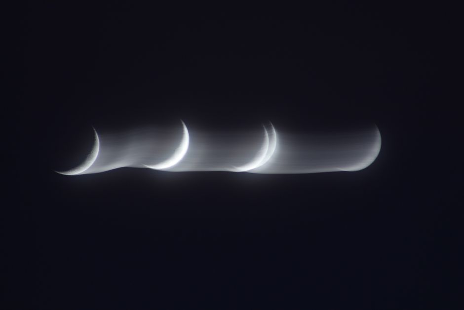Artistic capture of multiple crescent moon phases with a blurred motion effect at night.