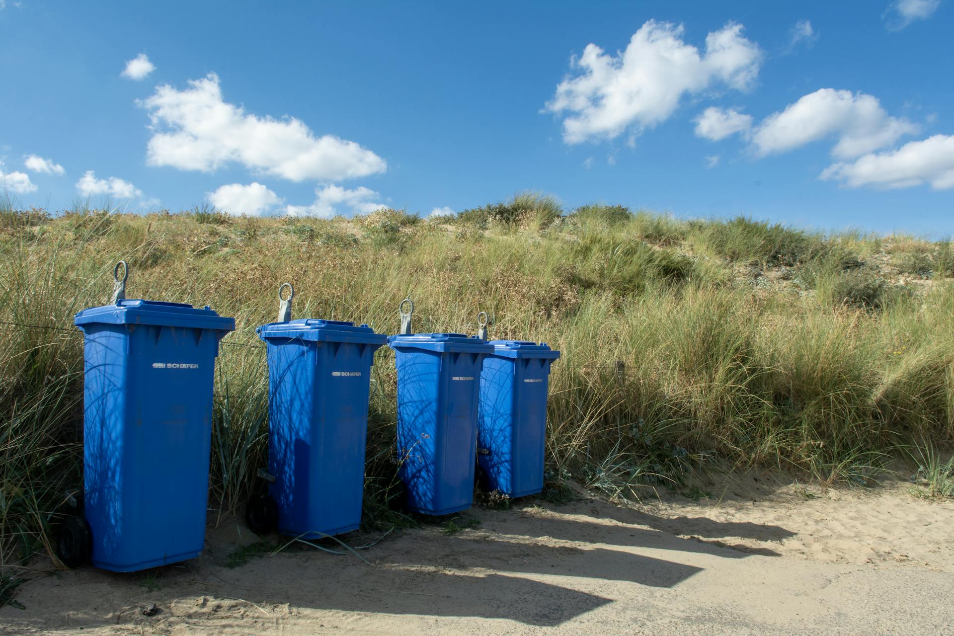 Blue Trash Cans by the Beach