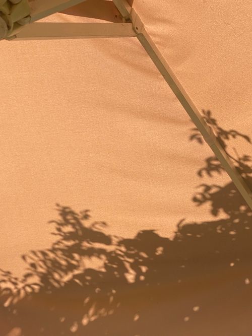 Free Artistic shadow play on a garden umbrella, capturing a serene summer vibe. Stock Photo