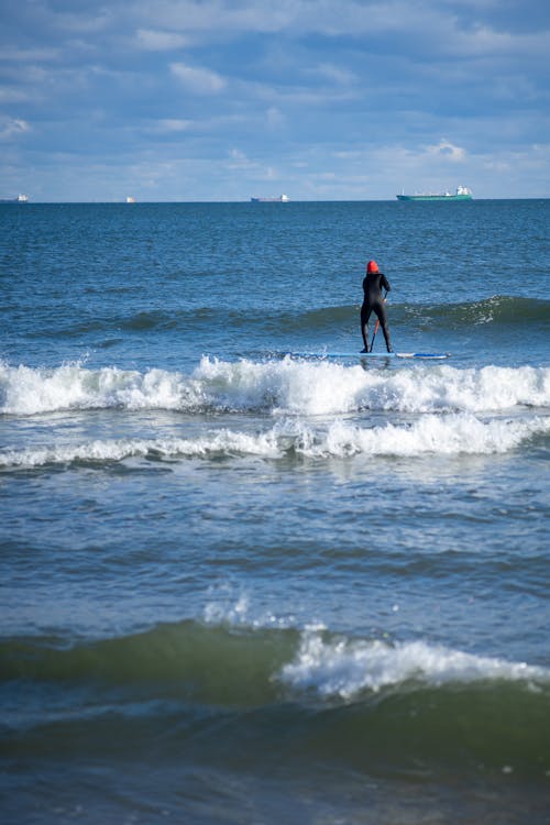 Person on Paddle Board on Sea Shore