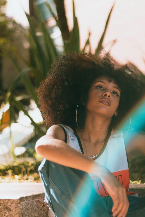 Woman with Curly Hair Sitting in Tank Top