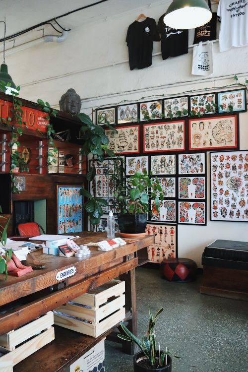 Free Interior of a lively tattoo parlor showcasing various tattoo designs and decor. Stock Photo