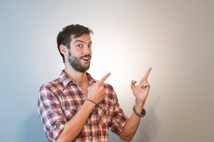 Man In A Plaid Shirt Posing For A Thumbnail