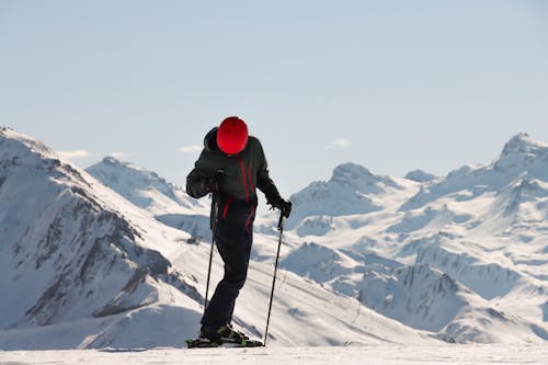 Skier with Red Helmet on Snowy Mountain