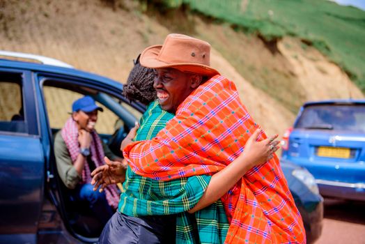 A warm hug shared between friends in a vibrant outdoor scene surrounded by nature.