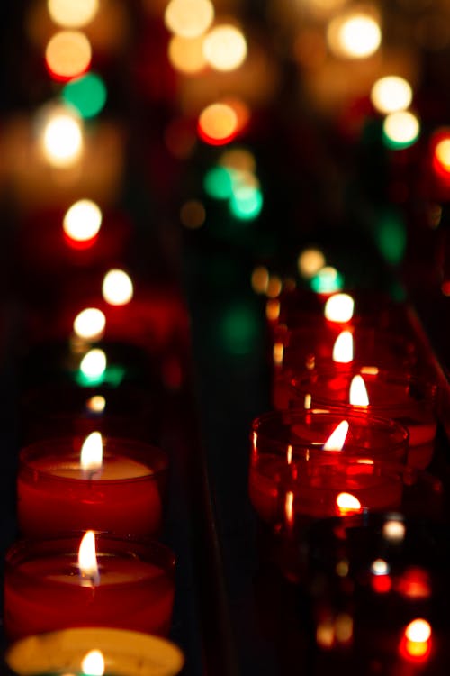 Close-up of Rows of Lit Candles 