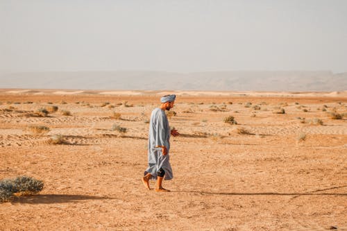 Man Walking on Barren Desert