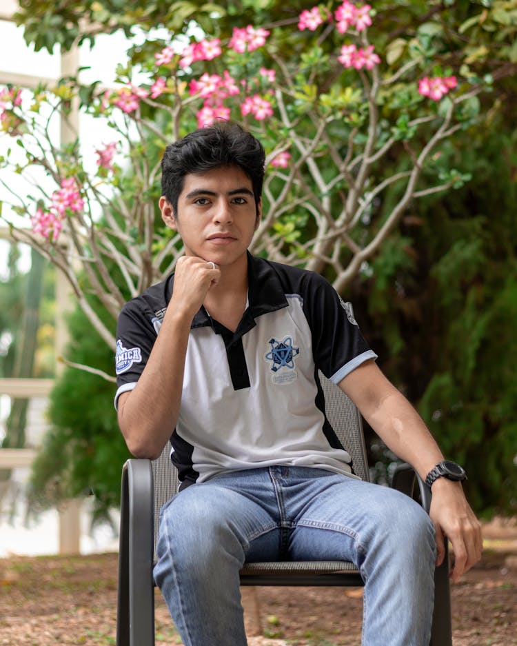 Brunette Man Sitting On Chair